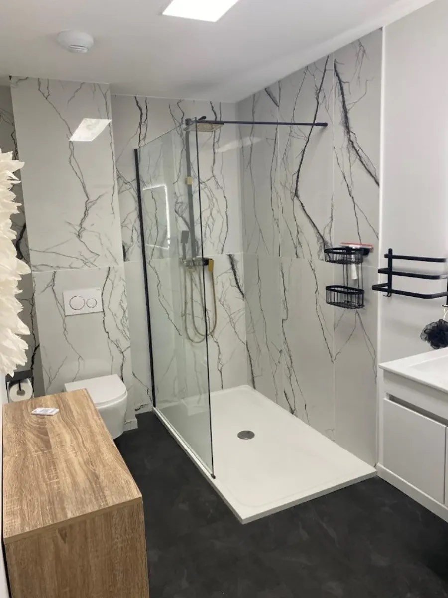 Douche à l'italienne avec paroi fixe et faïence effet marbre